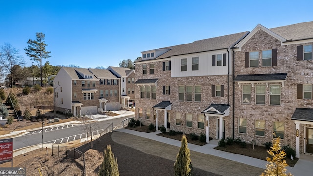 exterior space featuring a residential view and brick siding