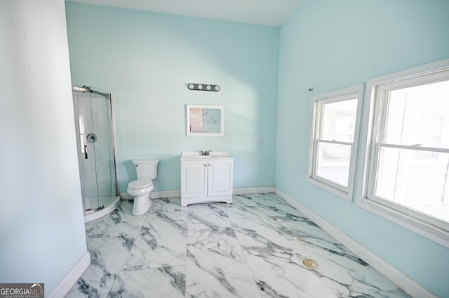 bathroom with toilet, a shower stall, baseboards, a towering ceiling, and vanity