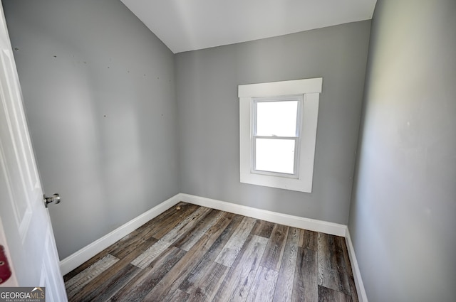 spare room featuring baseboards and wood finished floors