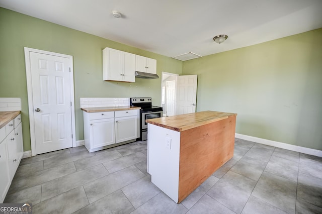 kitchen with electric range, white cabinets, under cabinet range hood, and butcher block counters