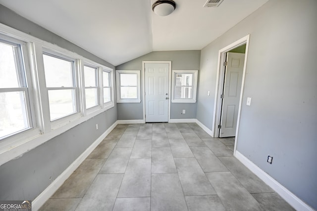 interior space featuring visible vents and vaulted ceiling