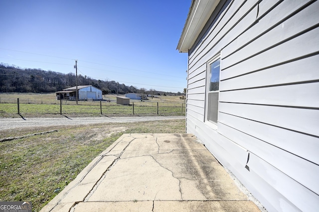 view of yard with a rural view and fence