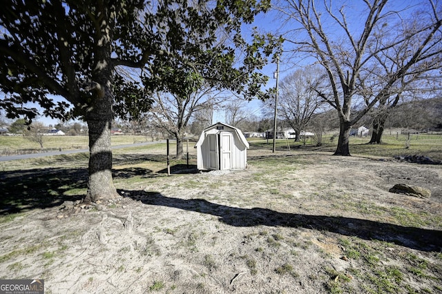 view of yard with an outdoor structure and a shed