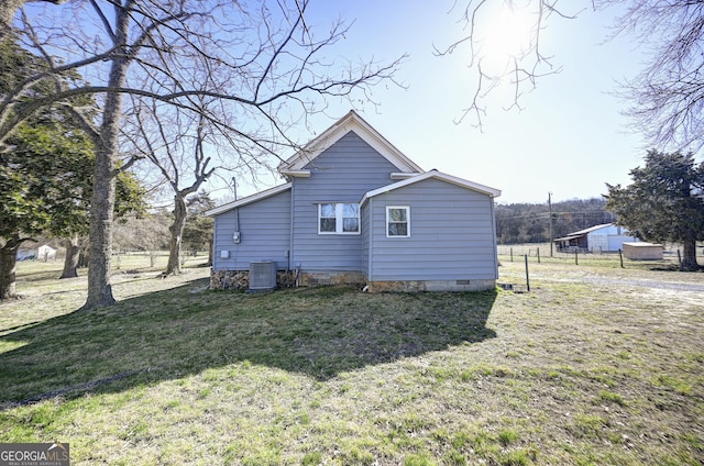 view of property exterior featuring a yard, cooling unit, and fence