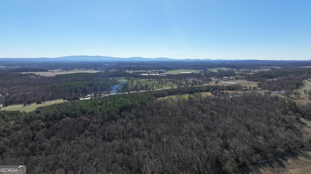 aerial view featuring a mountain view and a view of trees