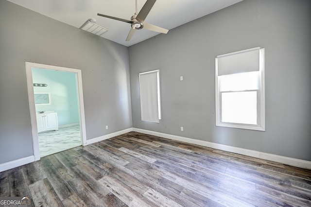 unfurnished room featuring visible vents, ceiling fan, baseboards, and wood finished floors