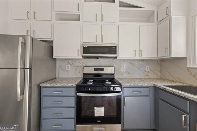 kitchen with stainless steel appliances, visible vents, white cabinetry, a sink, and light wood-type flooring