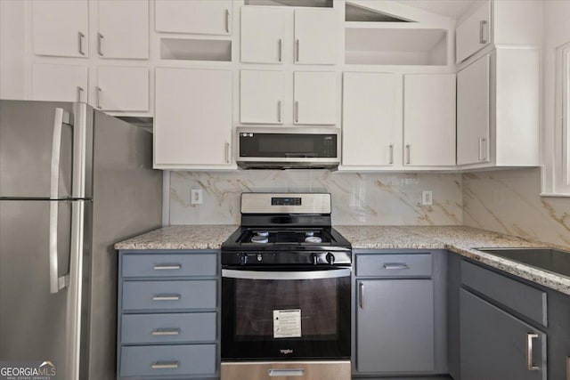 kitchen featuring white cabinetry, appliances with stainless steel finishes, backsplash, and gray cabinetry