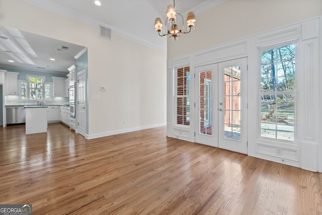 entryway featuring french doors, light wood-style floors, visible vents, and crown molding