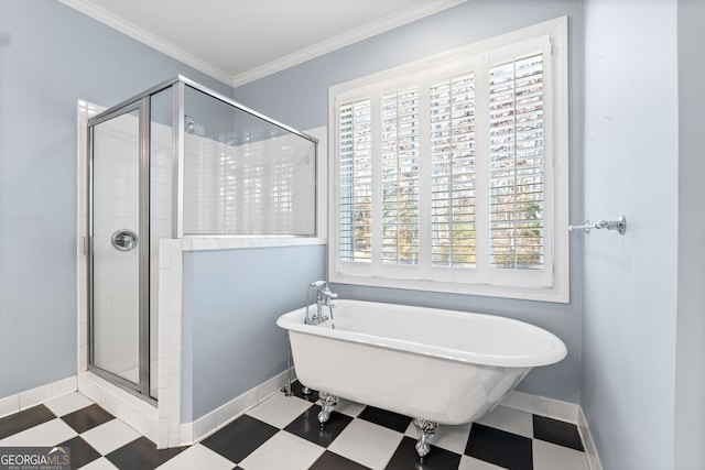 full bath featuring a stall shower, baseboards, tile patterned floors, crown molding, and a freestanding tub