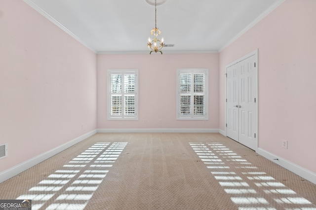 empty room featuring a notable chandelier, baseboards, visible vents, and crown molding