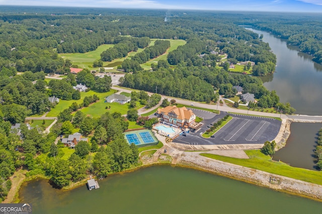 drone / aerial view featuring a water view and a forest view