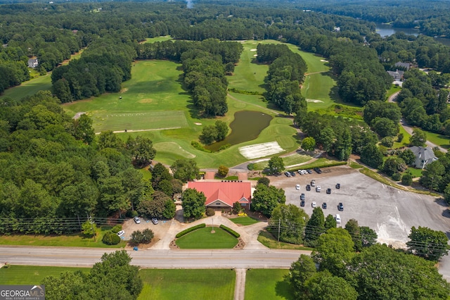 bird's eye view with a water view, a forest view, and golf course view