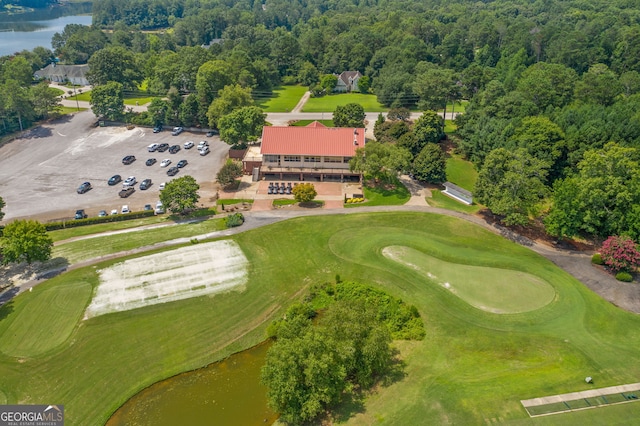 drone / aerial view featuring view of golf course and a water view