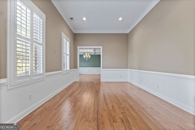 unfurnished room featuring a chandelier, recessed lighting, light wood-style flooring, and crown molding