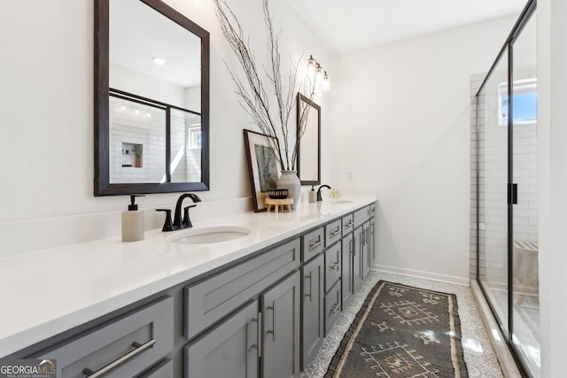 bathroom featuring a sink, a shower stall, and double vanity