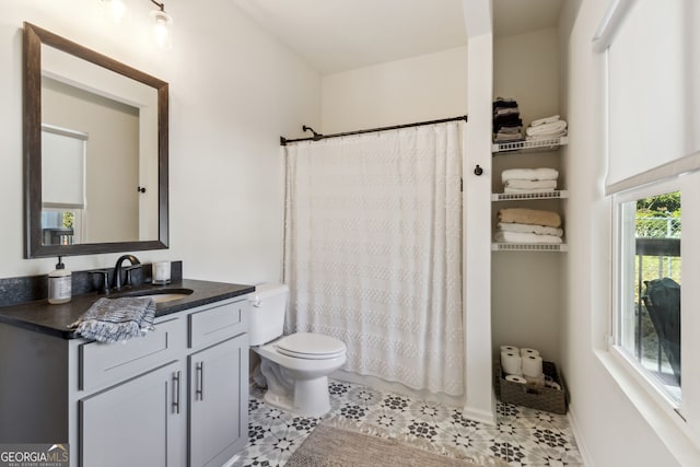 bathroom with toilet, tile patterned flooring, a shower with shower curtain, and vanity