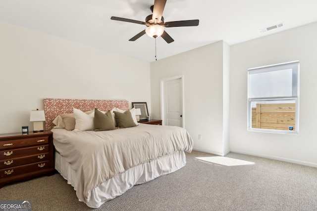 bedroom featuring ceiling fan, carpet floors, visible vents, and baseboards