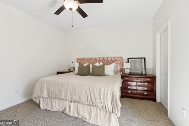 carpeted bedroom featuring baseboards and a ceiling fan