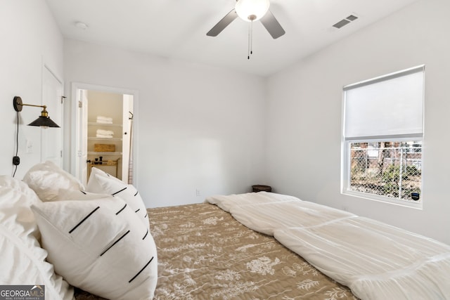 bedroom featuring ceiling fan, visible vents, and ensuite bathroom