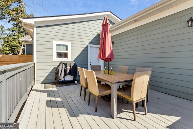 wooden deck featuring outdoor dining space and fence