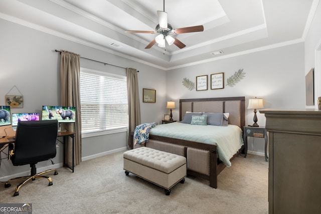 bedroom with ornamental molding, a tray ceiling, light carpet, and baseboards