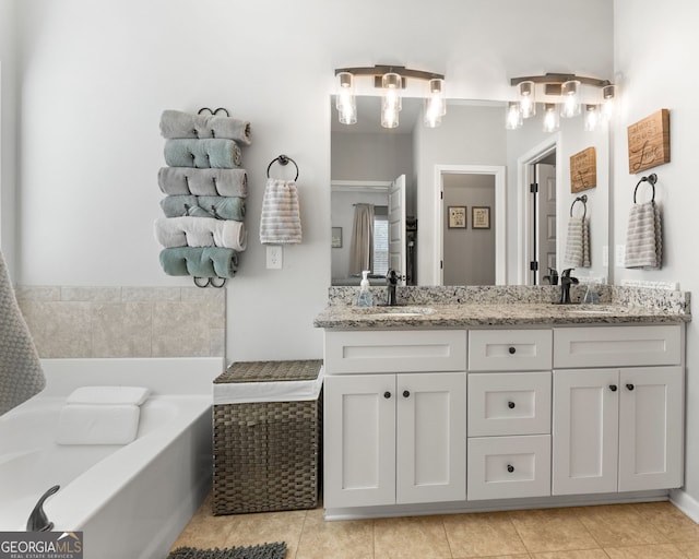 full bathroom featuring tile patterned flooring, a garden tub, a sink, and double vanity