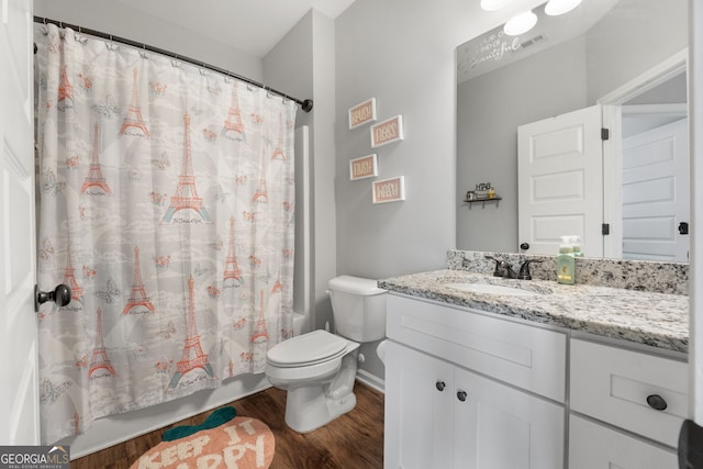 full bathroom with toilet, wood finished floors, vanity, visible vents, and shower / bath combo