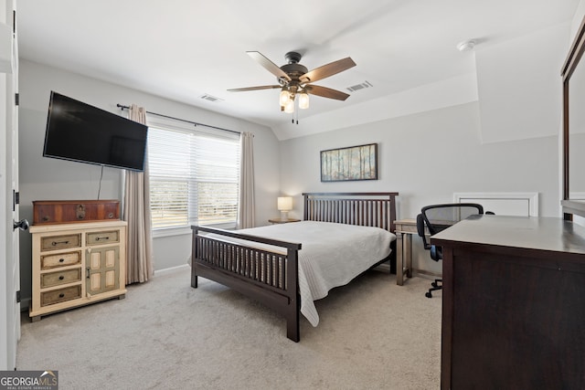 bedroom featuring light carpet, vaulted ceiling, visible vents, and a ceiling fan