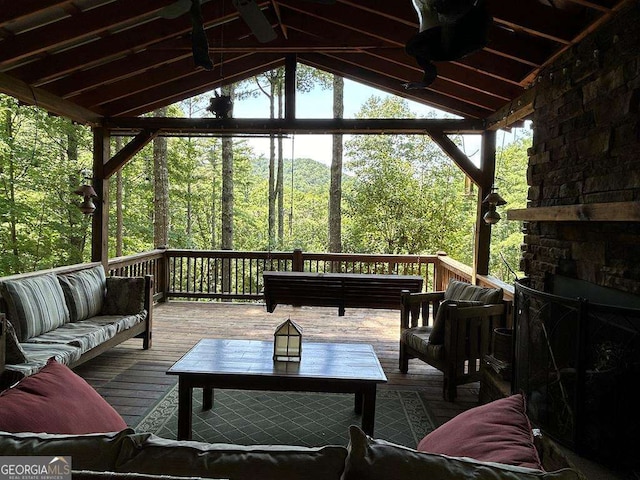 exterior space with outdoor lounge area and a view of trees