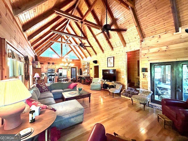 living room featuring wooden ceiling, beam ceiling, wood finished floors, and ceiling fan with notable chandelier
