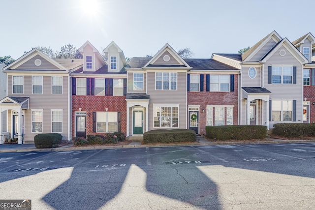 view of property featuring brick siding