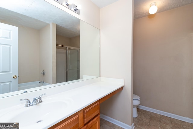 bathroom featuring a stall shower, baseboards, toilet, a textured ceiling, and vanity