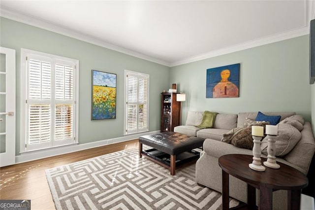 living room with ornamental molding, baseboards, and wood finished floors