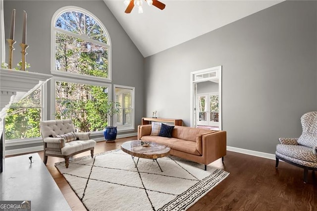 living area featuring high vaulted ceiling, a wealth of natural light, and wood finished floors