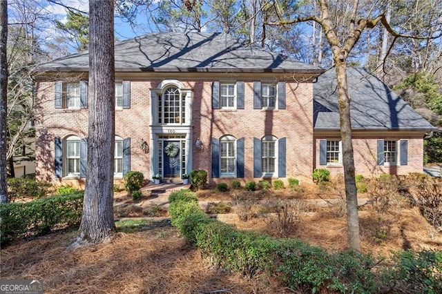 colonial home with brick siding