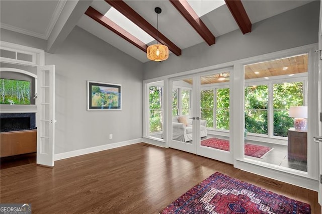 unfurnished living room featuring vaulted ceiling with beams, french doors, visible vents, and a wealth of natural light