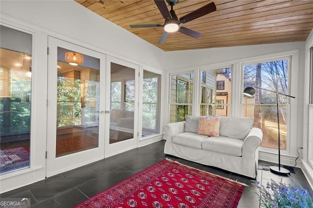 sunroom featuring a ceiling fan, plenty of natural light, wood ceiling, and vaulted ceiling