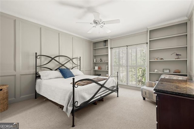 bedroom with light carpet, crown molding, a ceiling fan, and a decorative wall