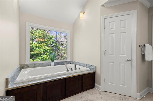 full bathroom featuring marble finish floor, vaulted ceiling, baseboards, and a bath