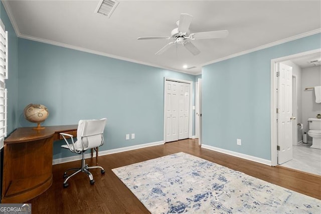 office featuring crown molding, wood finished floors, visible vents, and baseboards