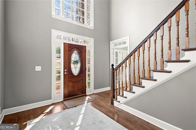 entryway featuring a healthy amount of sunlight, baseboards, and wood finished floors