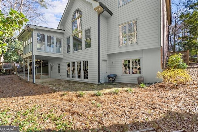 back of house featuring a sunroom and french doors