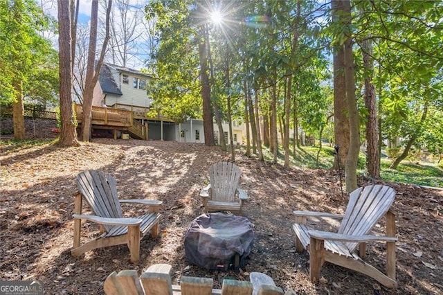 view of yard with a deck, an outdoor fire pit, and stairs