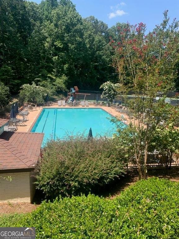 pool featuring a patio area and fence