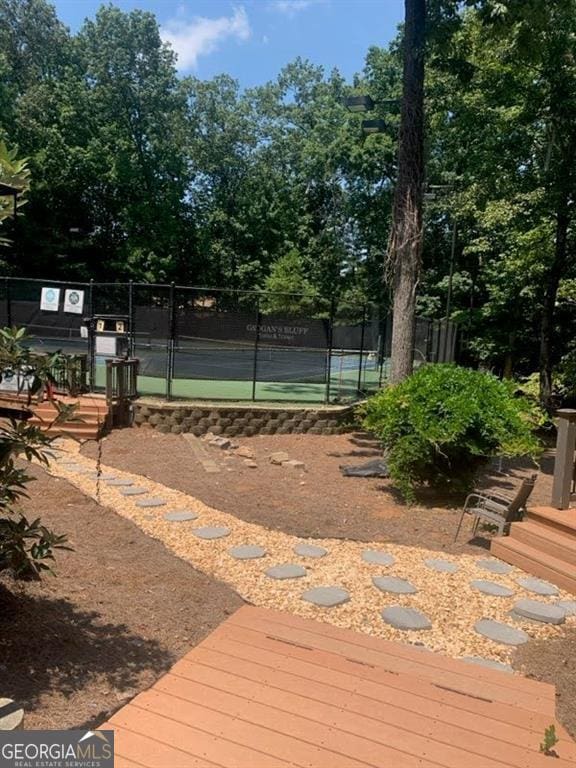 view of tennis court with fence