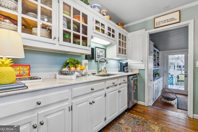 kitchen with a sink, white cabinets, ornamental molding, stainless steel dishwasher, and dark wood-style floors