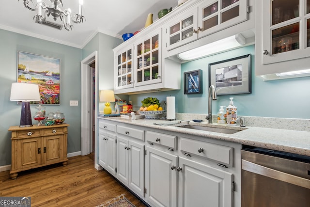 bar with stainless steel dishwasher, ornamental molding, a sink, wood finished floors, and baseboards