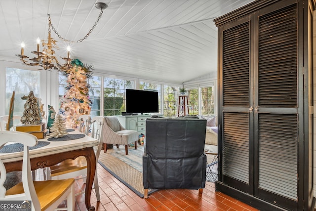 sunroom featuring wood ceiling, vaulted ceiling, and an inviting chandelier