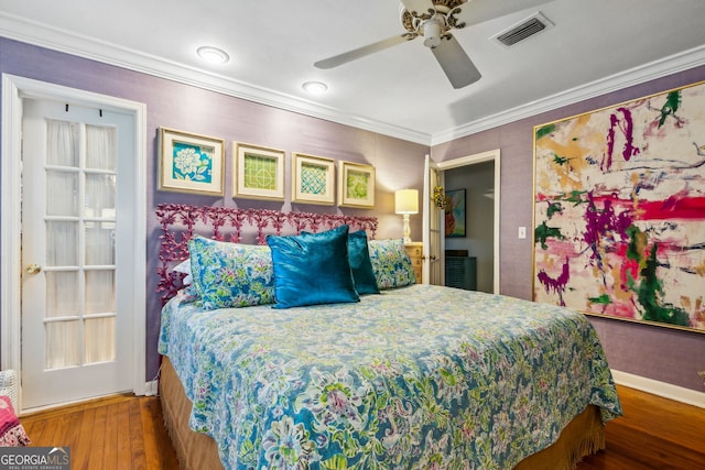 bedroom featuring baseboards, visible vents, ceiling fan, wood finished floors, and crown molding